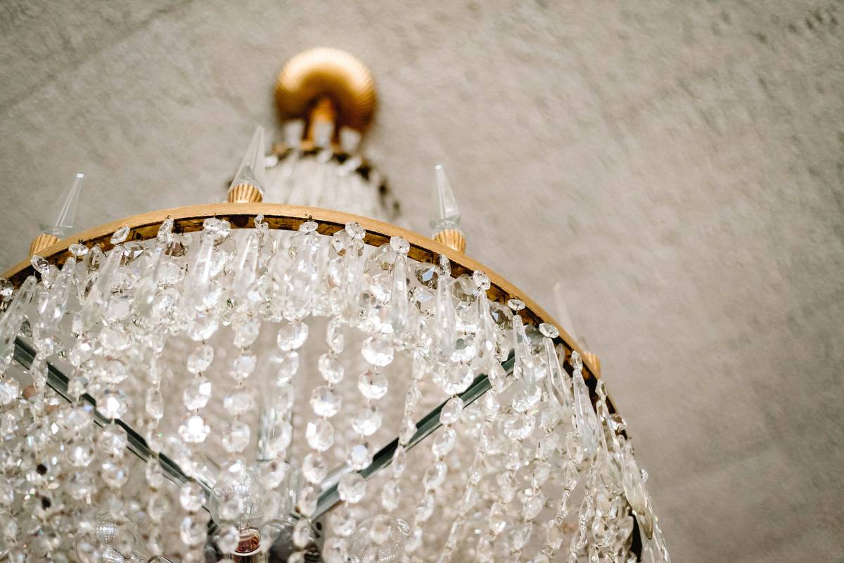 Close-up of lighting crystal chandeliers showing hand-cut crystal facets reflecting soft warm light