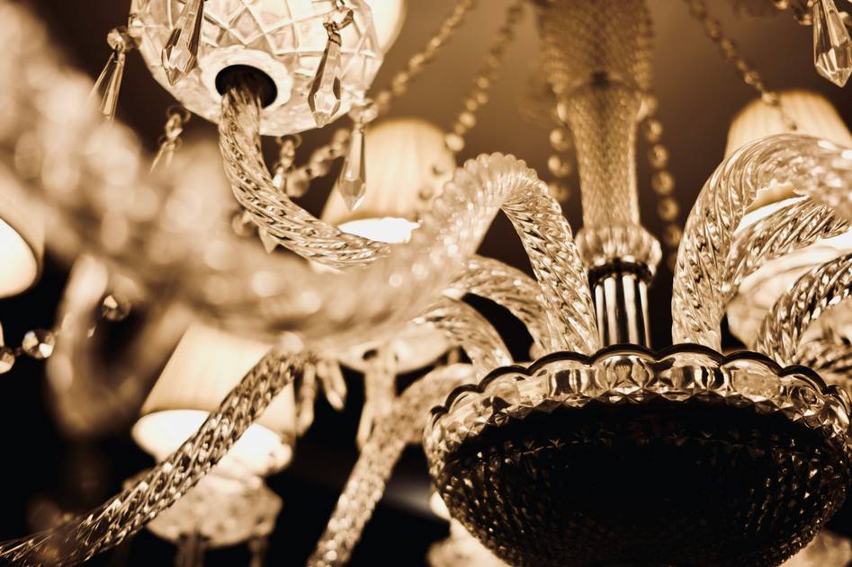 Close-up of crystal prisms refracting light from a classic chandelier